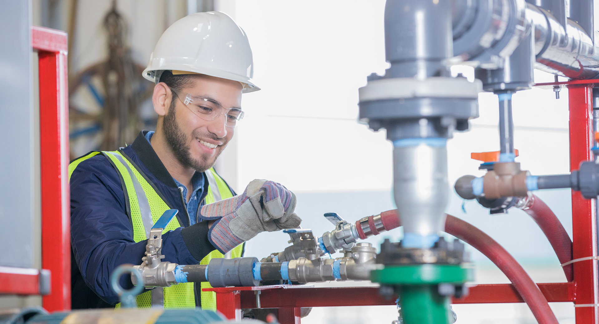 Young engineer working on pipeline equipment for oil and gas company Young engineer working on pipeline equipment for oil and gas company