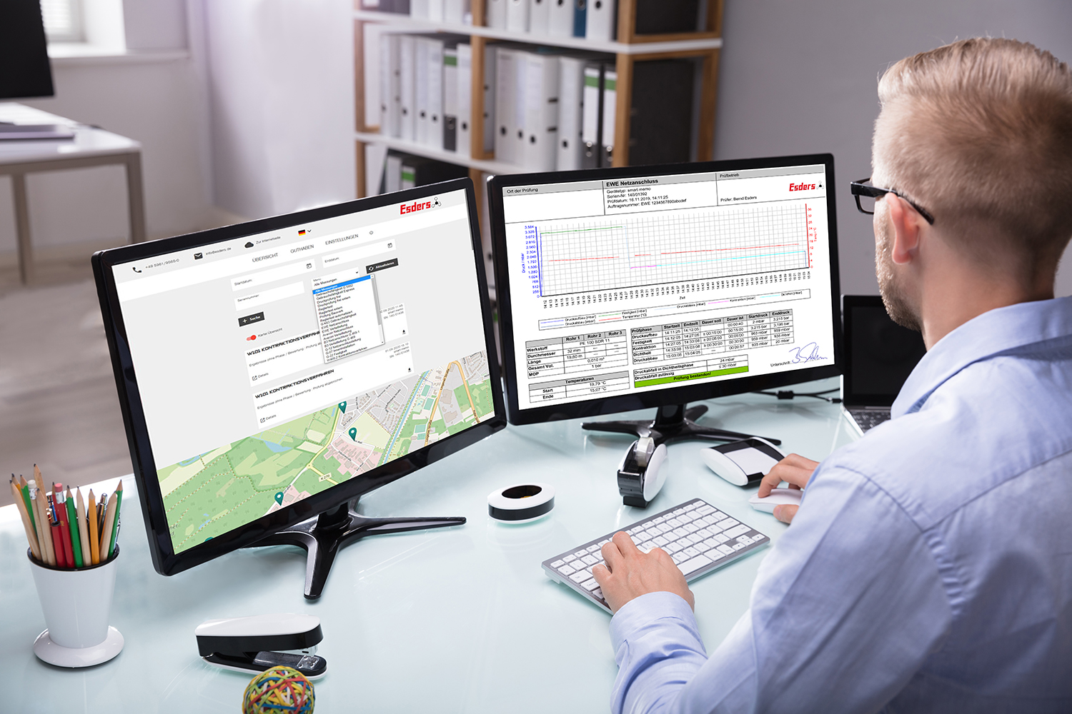 Young Businessman Analyzing Graph On Computer At Workplace